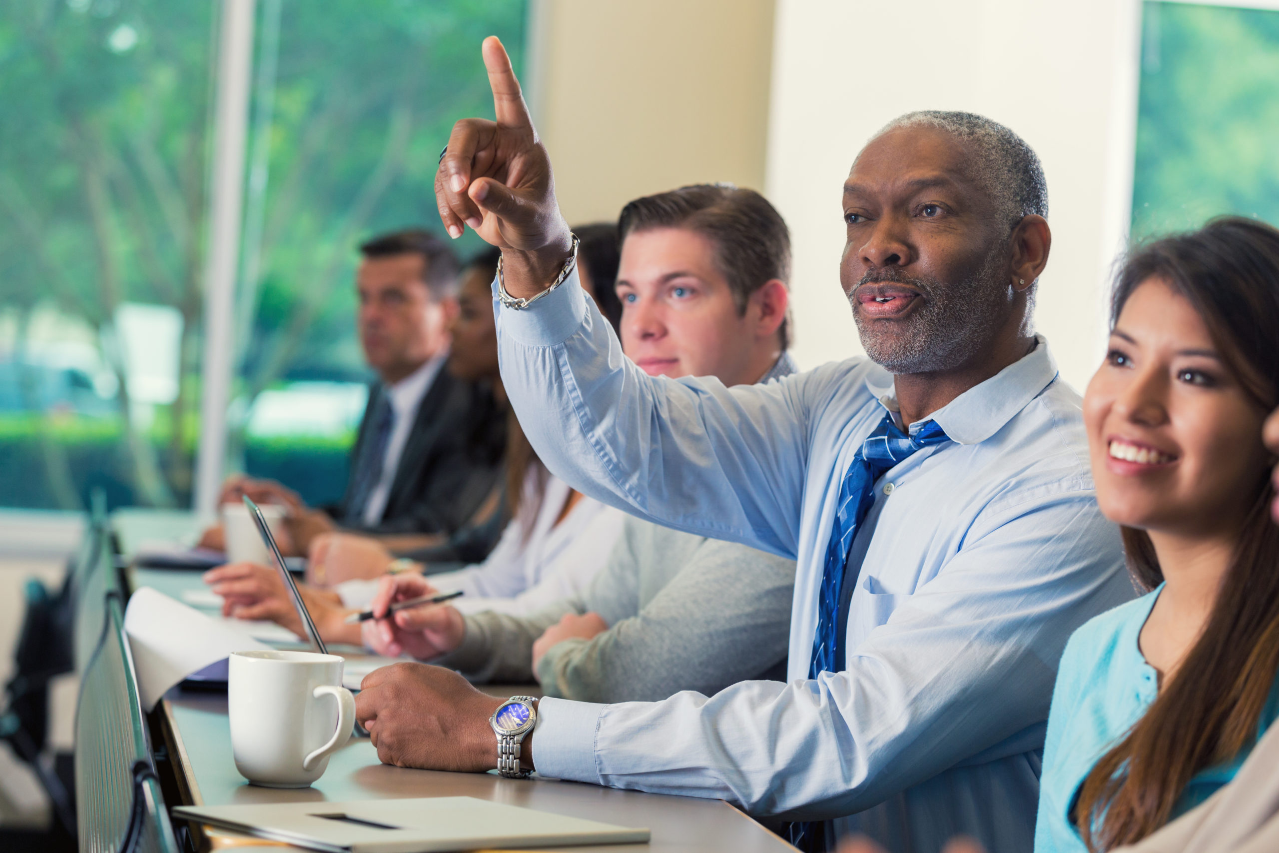Senior African American businessman asking question during business seminar conference