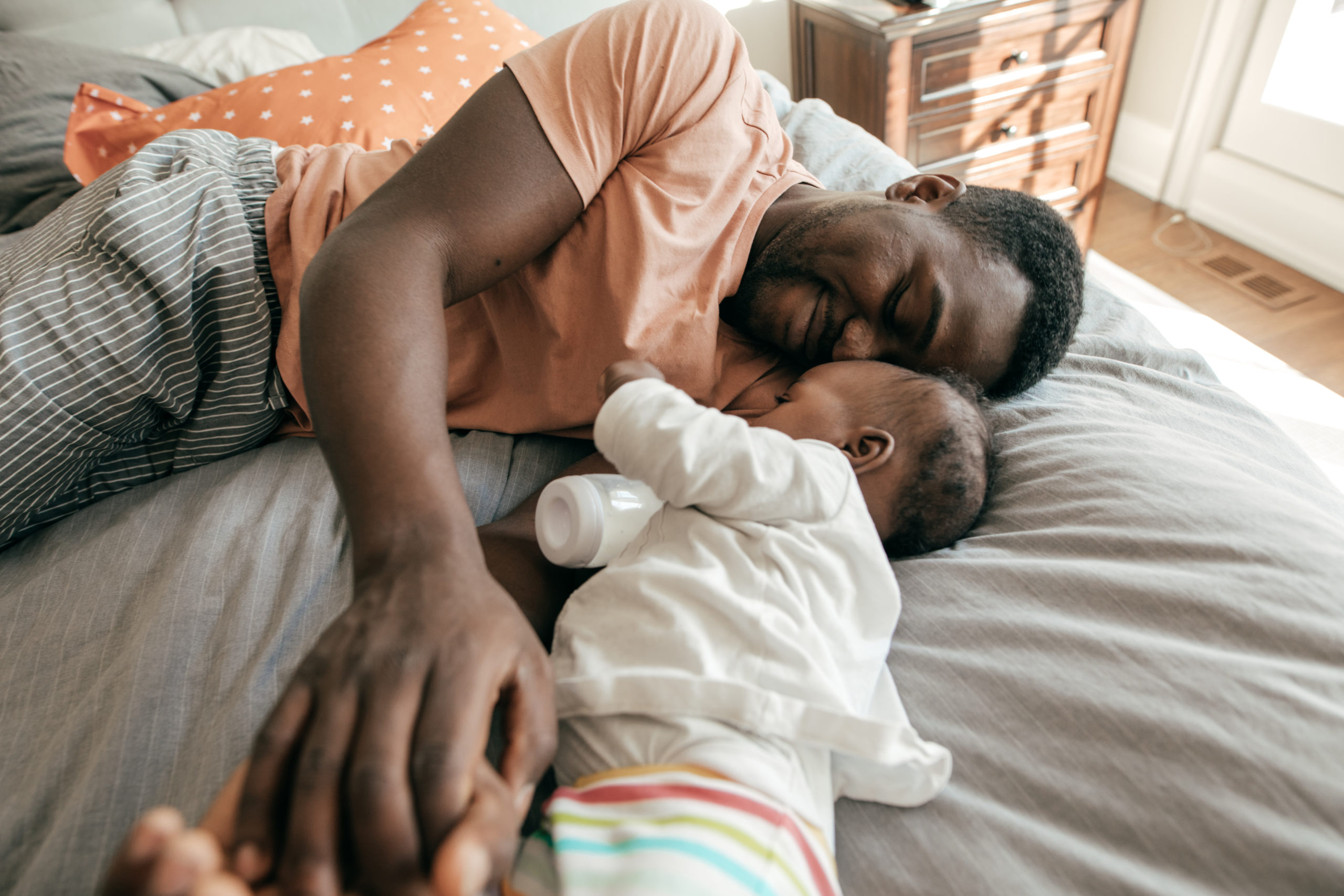 Happy father playing with toddler son